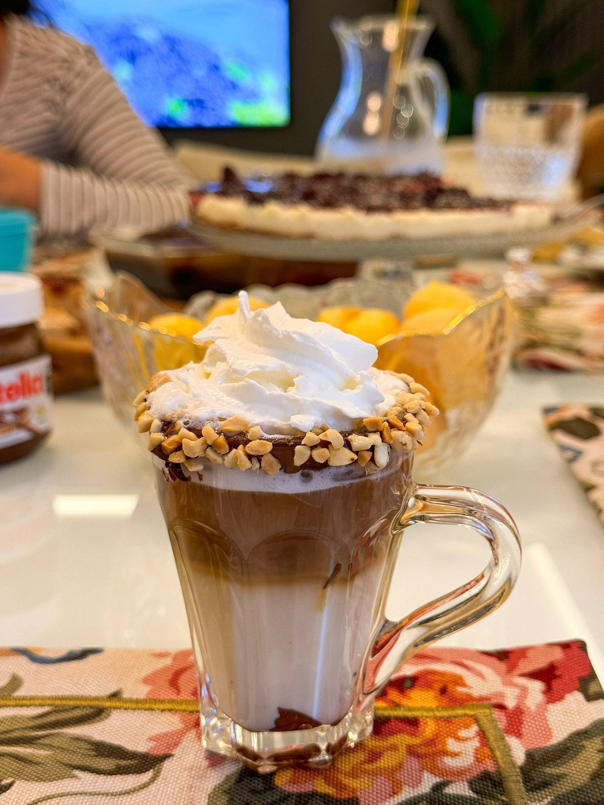 Café com chantilly e amendoim servido em taça de vidro